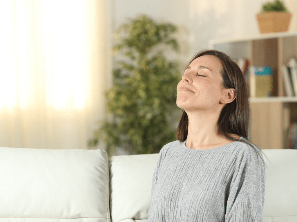 woman breathing in clean air in home